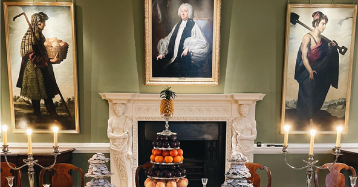 view of historic paintings on the wall around a fire place in Auckland Castle